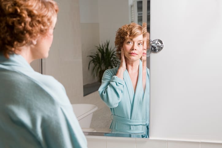 Woman looking in mirror